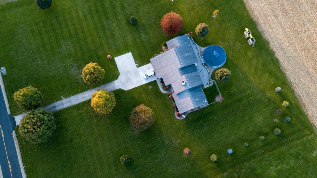 aerial photo of gray house with landscaped yard